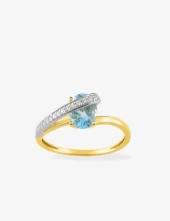 Bague en or jaune 750 ‰ avec topaze bleue, oxyde de zirconium et rhodium SO OR