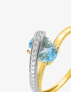 Bague en or jaune 750 ‰ avec topaze bleue, oxyde de zirconium et rhodium SO OR