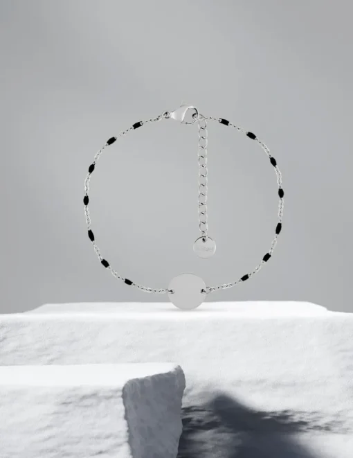 Bracelet fantaisie noir et acier, plaque ronde SO OR
